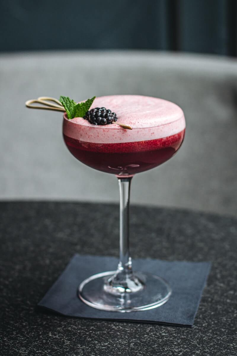 Coupe cocktail glasses with black cocktail